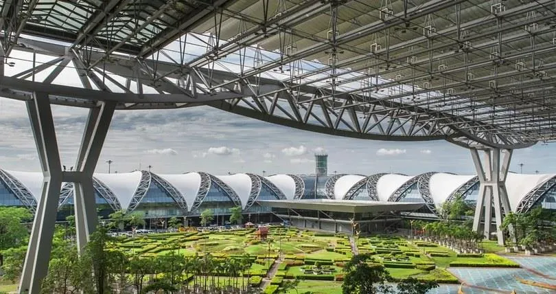Bangkok airport terminal roof above landscaped gardens