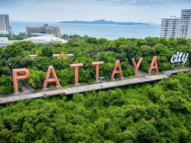 The Pattaya City sign on the hillside above the bay