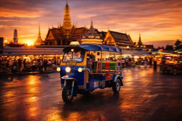 A tuk-tuk in front of a Bangkok temple at dusk