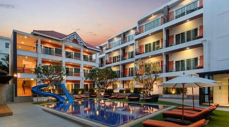 FX Hotel Pattaya at dusk, with its pool and sun loungers
